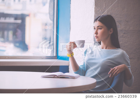 Young confident woman with cup 23660339