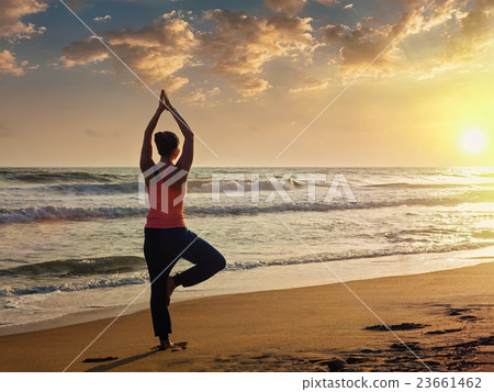 Young sporty fit woman doing yoga tree asana on Young sporty fit woman doing yoga tree asana on 23661462