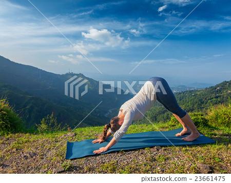 Young sporty fit woman doing yoga oudoors in 23661475