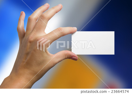 Hand holding white business card on blurred Hand holding white business card on blurred 23664574