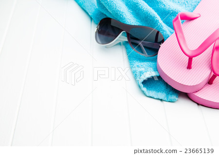 Pink flip flops with towel and sunglasses. Pink flip flops with towel and sunglasses. 23665139