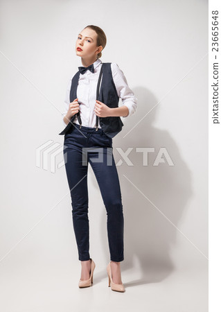 fashion model in black trousers, top, bow tie and fashion model in black trousers, top, bow tie and 23665648