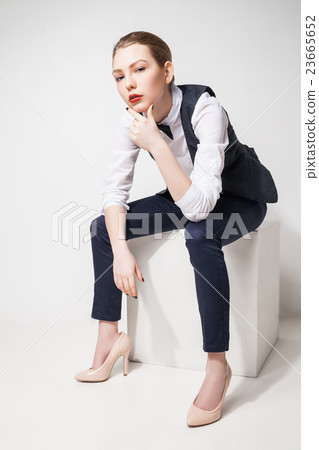 fashion model in black trousers, top, bow tie and 23665652
