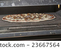 Pizza baking in the oven 23667564
