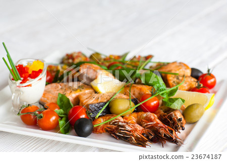 Grilled assorted seafood ,blurred background, void Grilled assorted seafood ,blurred background, void 23674187