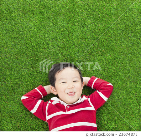 A funny kid lying and holding his head 23674873