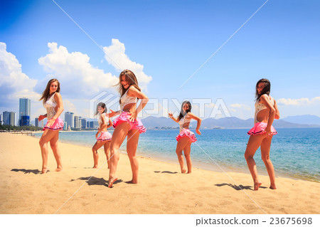 cheerleaders dance one hand aside on beach 23675698