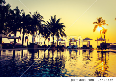 Beautiful Silhouette palm tree with umbrella and chair Beautiful Silhouette palm tree with umbrella and chair 23678336