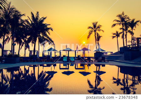 Beautiful Silhouette palm tree with umbrella and chair Beautiful Silhouette palm tree with umbrella and chair 23678348