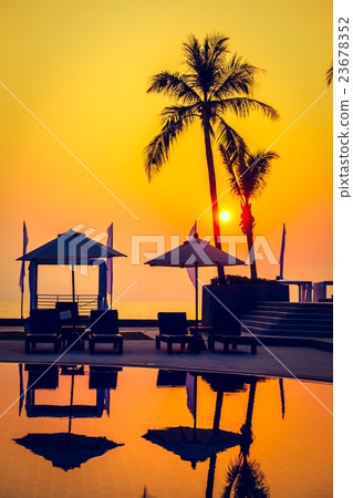 Beautiful Silhouette palm tree with umbrella and chair Beautiful Silhouette palm tree with umbrella and chair 23678352