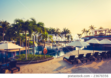 Beautiful Silhouette palm tree with umbrella and chair Beautiful Silhouette palm tree with umbrella and chair 23678356