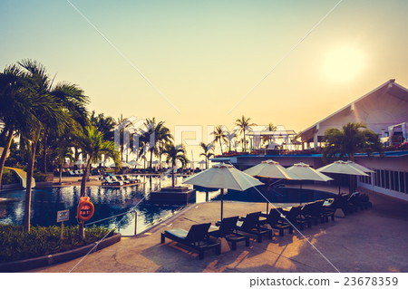 Beautiful Silhouette palm tree with umbrella and chair Beautiful Silhouette palm tree with umbrella and chair 23678359