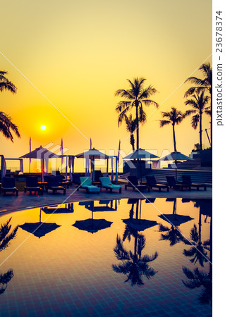 Beautiful Silhouette palm tree with umbrella and chair Beautiful Silhouette palm tree with umbrella and chair 23678374