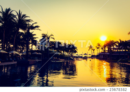 Beautiful Silhouette palm tree with umbrella and chair Beautiful Silhouette palm tree with umbrella and chair 23678382