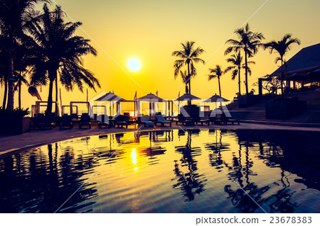 Beautiful Silhouette palm tree with umbrella and chair 23678383