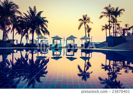 Beautiful Silhouette palm tree with umbrella and chair Beautiful Silhouette palm tree with umbrella and chair 23678401