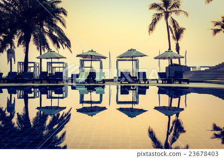 Beautiful Silhouette palm tree with umbrella and chair Beautiful Silhouette palm tree with umbrella and chair 23678403