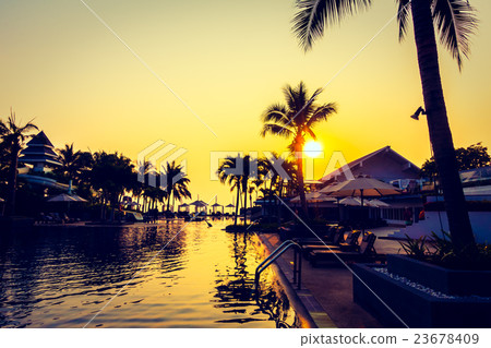 Beautiful Silhouette palm tree with umbrella and chair Beautiful Silhouette palm tree with umbrella and chair 23678409