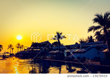 Beautiful Silhouette palm tree with umbrella and chair Beautiful Silhouette palm tree with umbrella and chair 23678410
