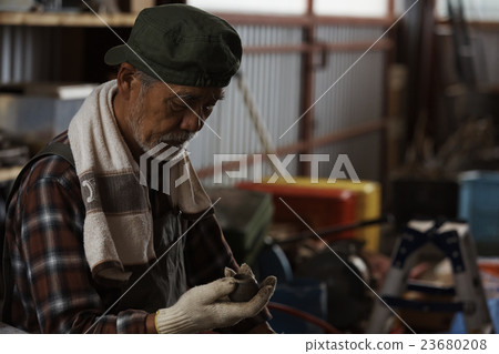 Men maintaining tractors Men maintaining tractors 23680208
