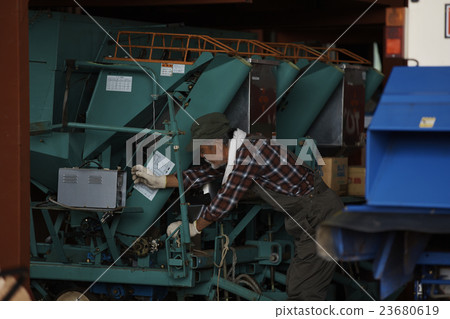 Farmers using agricultural machinery 23680619