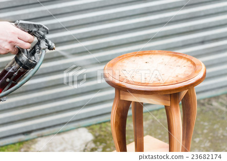 Carpenter is covering stool by lacquer Carpenter is covering stool by lacquer 23682174