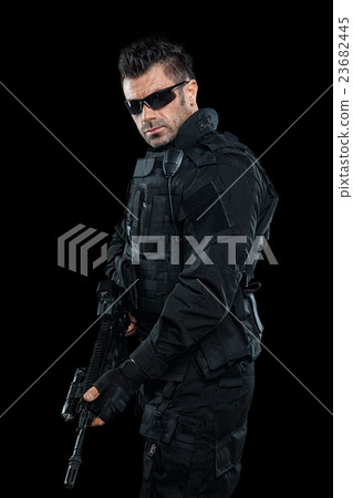 Three soldiers in full uniform with guns is going  23682445