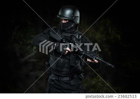 Three soldiers in full uniform with guns is going  23682513