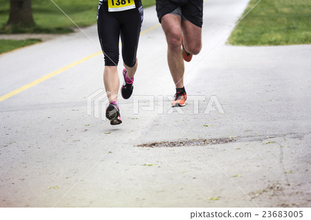 Young couple running in the city park Young couple running in the city park 23683005