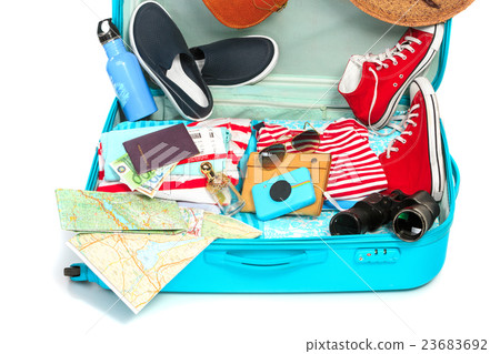 The open blue suitcase, sneakers, clothing, hat The open blue suitcase, sneakers, clothing, hat 23683692