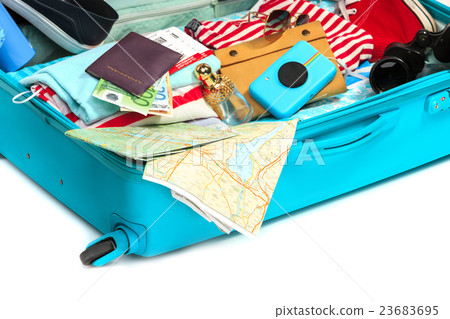 The open blue suitcase, sneakers, clothing, hat The open blue suitcase, sneakers, clothing, hat 23683695