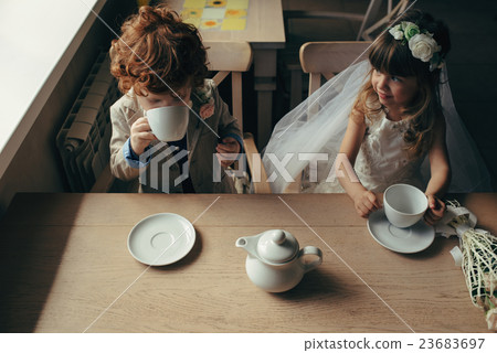 boy and girl having tea party in cafe boy and girl having tea party in cafe 23683697
