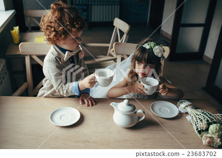 boy and girl having tea party in cafe boy and girl having tea party in cafe 23683702