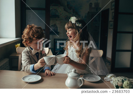 boy and girl having tea party in cafe boy and girl having tea party in cafe 23683703