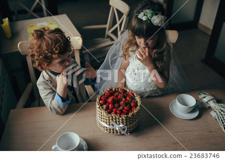 boy and girl having tea party in cafe 23683746