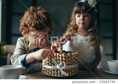 boy and girl having tea party in cafe 23683748