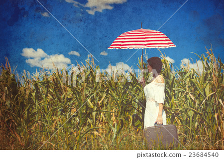 young woman with suitcase and umbrella 23684540