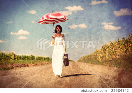 young woman with suitcase and umbrella 23684542