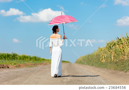 young woman with umbrella 23684556