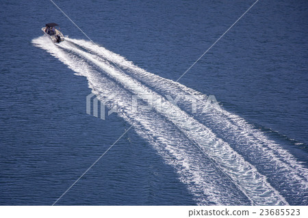 Speedboat rides on the sea 23685523