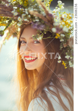 Beautiful girl in meadow in national suite 23686156