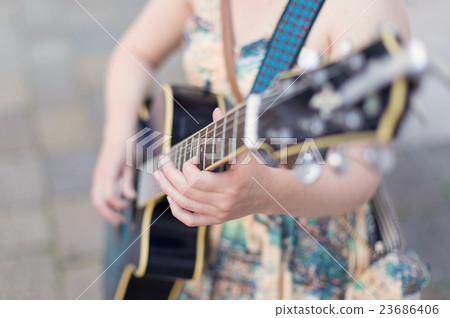 Female street musician playing guitar. Female street musician playing guitar. 23686406