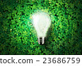 Glowing light bulb on green grass background  23686759