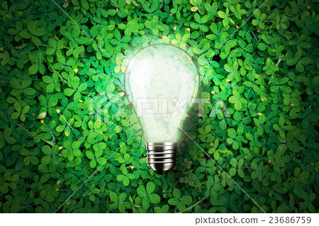 Glowing light bulb on green grass background Glowing light bulb on green grass background 23686759