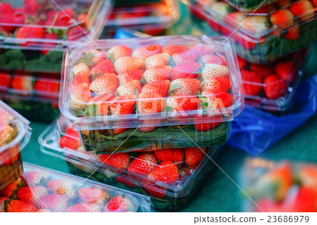 red strawberry in plastic box 23686979