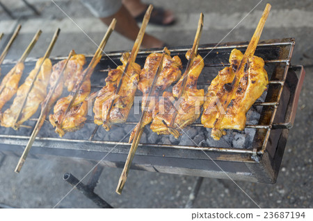 Hot Grilling chickens plugged with bamboo Hot Grilling chickens plugged with bamboo 23687194