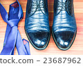 Classic men shoes and blue tie on wood background 23687962