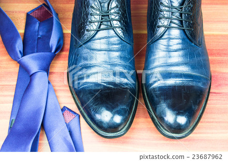 Classic men shoes and blue tie on wood background Classic men shoes and blue tie on wood background 23687962