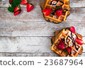 Belgium waffles with strawberries and chocolate.  23687964
