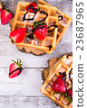 Belgium waffles with strawberries and chocolate.  23687965